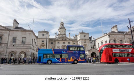 London, England - Circa September, 2018: A blue open top double decker bus for London city tour in front of the Household Calvary building