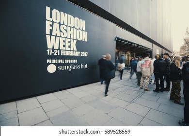 London, England - February 17, 2017: People in motion at the entrance of London Fashion Week.