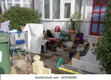 LONDON, ENGLAND - FEBRUARY 28, 2017: Messy, Untidy Terraced House Front Garden UK.