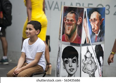 LONDON, ENGLAND - JULY 12, 2016 Street Artist Paints A Portrait Of A Boy