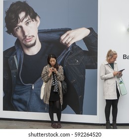 LONDON, ENGLAND - JULY 12, 2016 Two Girls Standing Near Advertising Poster With Adam Driver In Piccadilly Circus