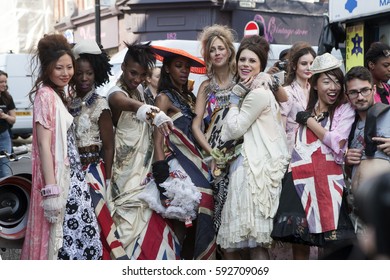 LONDON, ENGLAND - JULY 12, 2016 Brightly Dressed Women In A Typical East London Style Are On Brick Lane. Street Fashion