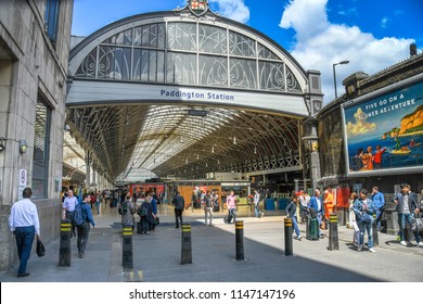 LONDON, ENGLAND - JULY 2018: Rail travellers and commuters entering and leaving the entrance to London Paddington railway station.