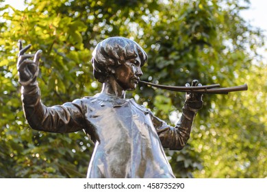 LONDON, ENGLAND - JULY 23, 2016: Peter Pan statue in the Kensigton Gardens. Peter Pan is a fictional character made by Scottish novelist  J. M. Barrie.