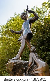 LONDON, ENGLAND - JULY 23, 2016: Peter Pan Statue In The Kensigton Gardens. Peter Pan Is A Fictional Character Made By Scottish Novelist  J. M. Barrie.