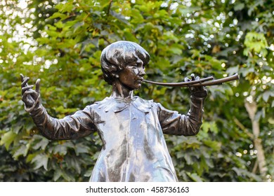 LONDON, ENGLAND - JULY 23, 2016: Peter Pan statue in the Kensigton Gardens. Peter Pan is a fictional character made by Scottish novelist  J. M. Barrie.