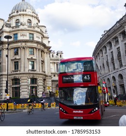 LONDON, ENGLAND - JULY 28 2020: A London Bus And A Group Of Cyclists Pass Ways At Bank Junction.