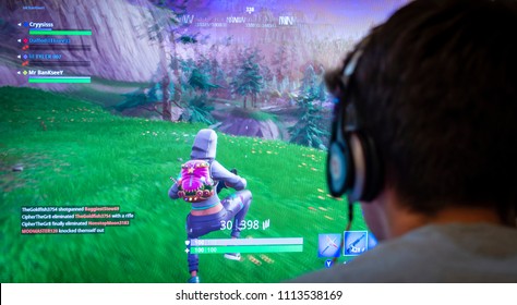 London, England - June 13, 2018: Teenager playing Fortnite video game, Fortnite is a web based multi player survival game developed by Epic Games.