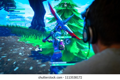 London, England - June 13, 2018: Teenager playing Fortnite video game, Fortnite is a web based multi player survival game developed by Epic Games.