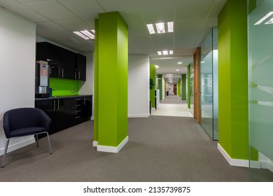 London, England - June 16 2010: Empty Modern Office Building Corridor Containing Offices, Frosted Glazing And Refreshment Station And Contemporary Bright Green Decor