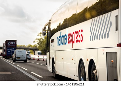 London, England - June 25 2019. National Express Coach Travelling Down Motorway 