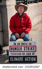 London, England - March 21, 2022: A Man Protesting Climate Change By Not Eating Sits On A London Street Advertising His Hunger Strike In An Effort To Motivate Others To Take Action.