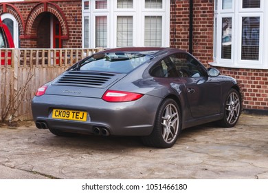 LONDON, ENGLAND - MARCH 6, 2017: 2009 Grey Porsche Carrera Parked On A Driveway, London.