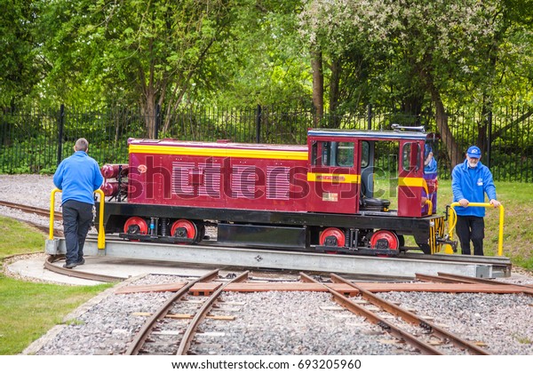 London, England -\
May 2017 : Narrow gauge tourist train locomotive changing\
railtracks, Ruislip Lido, London,\
UK