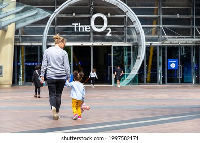 London, England - May 9, 2021: A mother and child walking towards the entrance of the famous O2 Arena, which holds various events including musical concerts, sports tournaments, and shopping mall