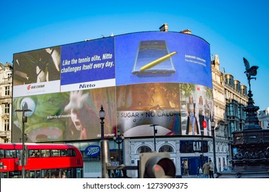 London, England - November 18, 2018: Piccadilly Square With Big Billboard And Bus Passing On The Street