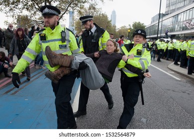 London, England. October 15th, 2019. Extinction Rebellion protesters stage a demonstration outside Millbank Tower in London. Protestors blocking the road were arrested.