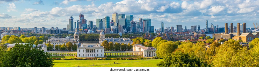 London, England, Panoramic Skyline View Of Greenwich College and Canary Wharf At Golden Hour Sunset With Blue Sky And Clouds 