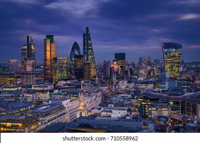 London, England - Panoramic skyline view of Bank district of London with the skyscrapers of Canary Wharf at the background at blue hour