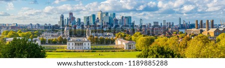 London, England, Panoramic Skyline View Of Greenwich College and Canary Wharf At Golden Hour Sunset With Blue Sky And Clouds 