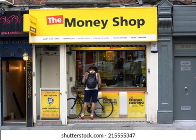 London, England - Sept 4th, 2014: A man stands at the window of The Money Shop in the Soho area of London. The Money Shop provides payday loans, pawn brokering and other financial services in the UK