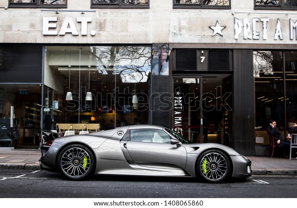 London, England -\
September 2018: Porsche 918 Spyder supercar parked near a cafe in\
Mayfair district of central London. Only 918 of these cars were\
made by the German\
brand.