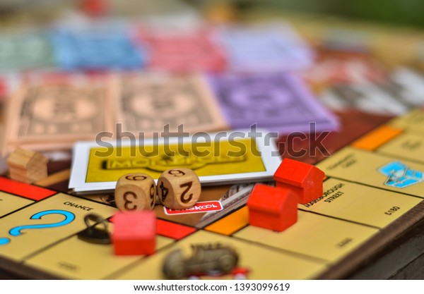 London,\
England, UK, 2020. Red houses, dice and Monopoly game cards on the\
game board with fake paper currency money in the background.\
Playing at home in quarantine during lockdown\
