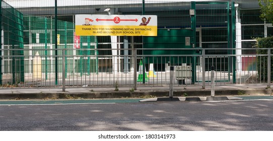 London, England, UK - 26/08/2020: Large Diverse Image Social Distancing Sign Outside Of School Entrance