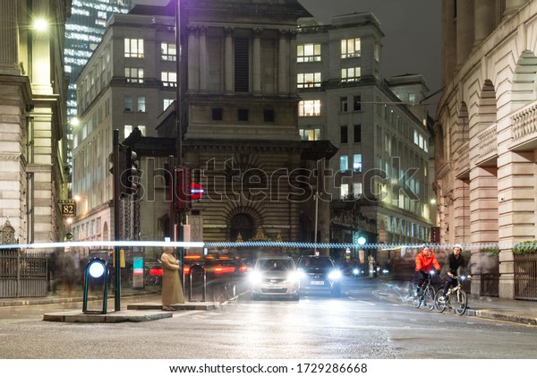 London,\
England, UK - January 11, 2018: Traffic waits at signals at Bank\
junction in the city of London, with St Mary Woolnoth church and\
office blocks of King William Street\
behind.