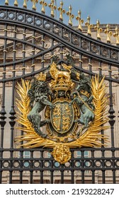 London, England, UK - July 6, 2022: Buckingham Palace. Closeup Of Golden Royal Coat Of Arms Fixed To Black Metal Main Gate.