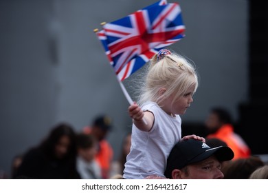 London, England, UK - June 5, 2022: A Child Holds Flags During Queen Elizabeth II Platinum Jubilee, Pageant. Credit: Loredana Sangiuliano