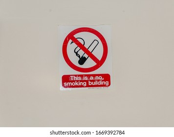 London, England, UK - March 10, 2020: Smoking Free Building Sign, An Red And White Sign With Cigarette Icon And Not Symbol
