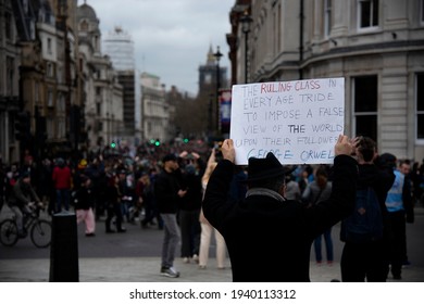 London, England, UK - March 20, 2021: Protester holds sign "The Ruling Class..." in Trafalgar Square during the Coronavirus Lockdown Restrictions Demonstration. Credit: Loredana Sangiuliano