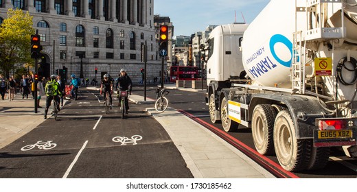 London, England, UK - May 4, 2016: Cyclists Ride Past A Construction Lorry On London's Segregated CS6 Cycle Superhighway On Blackfriars Bridge.