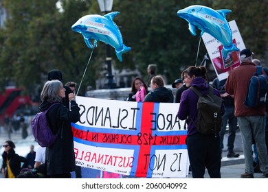 London, England, UK - October 16, 2021: Protesters hold signs at Stop the Whale and Dolphin Slaughter Protest at Trafalgar Square. Credit: Loredana Sangiuliano
