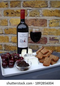 London, England, UK on August 17, 2011. French Chat O Souris red wine , British cheeses, onion chutney, cherries and rye bread in London, UK.                             