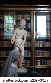 London, England UK - Sept 24 2022: Out Of Focus Nun Walking Past Cupid's Statue At The British Museum 