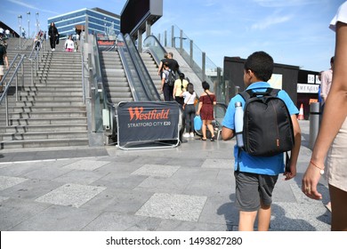 LONDON , England / United Kingdom August 2019 Shoppers on the steps to of Westfield Stratford City, the largest urban shopping centre in Europe