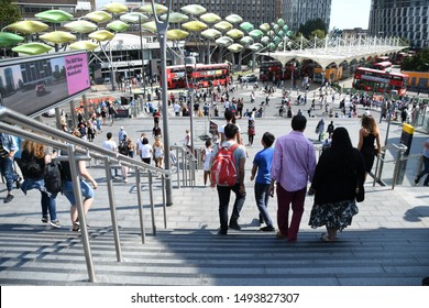 LONDON , England / United Kingdom August 2019 Shoppers on the steps to of Westfield Stratford City, the largest urban shopping centre in Europe