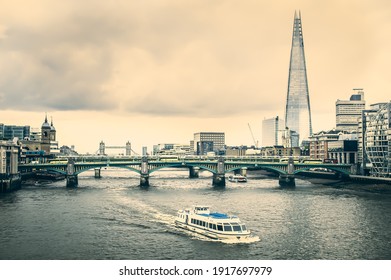 London, England, United Kingdom, May 2016: Thames River, A Boat and The Shard - Famous Building Landmark with Rooftop View - Seen from Millennium Bridge