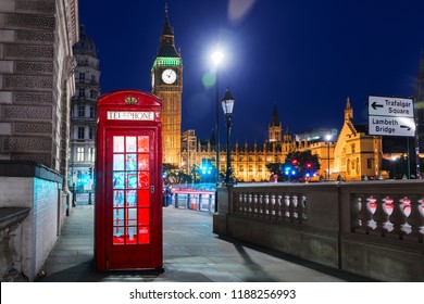 London, England, United Kingdom - Popular tourist Big Ben and Houses of Parliament with red phone booth in night lights illumination - Powered by Shutterstock