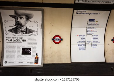 LONDON, ENGLAND/U.K. - AUGUST 30, 2019: Photo Of A Curved Wall Inside The London Waterloo Train Station, With A Jack Daniels Ad And Train Routing Map.