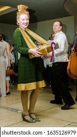 London, Enlgand, 18/04/2019 A Vintage Art Deco Style Movie Theatre Refreshment Serving Woman Attendant At An Intermission Movie Break, Selling Ice Creams And Soda Drinks. Vintage Costume.