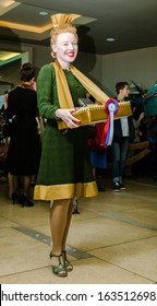 London, Enlgand, 18/04/2019 A Vintage Art Deco Style Movie Theatre Refreshment Serving Woman Attendant At An Intermission Movie Break, Selling Ice Creams And Soda Drinks. Vintage Costume.