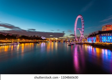 london eye at night with reflections.