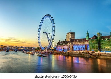 The London Eye on the South Bank of the River Thames at night in London, England.