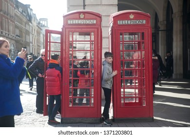 LONDON - FEBRUARY 17, 2019: A Boy Posing Against The Background Of A Red Phone Booth