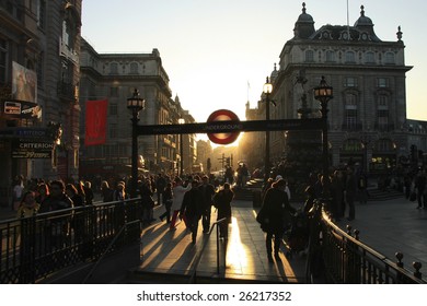 LONDON - FEBRUARY 17: Tourists and Commuters walk in the famous Piccadilly Circus as the sun is setting on February 17, 2008 in London, England.