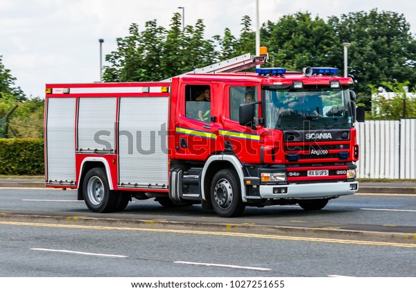 LONDON, HEATHROW / UK -\
15 JULY 2014: Fire fighting engine vehicle Scania responding and\
drive to the fire