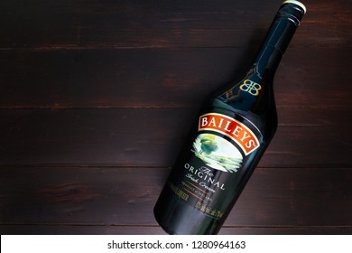 LONDON - JANUARY 08, 2019: Baileys Irish Cream Glass Bottle On Dark Wood Background